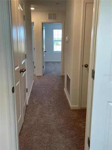 a view of hallway with livingroom