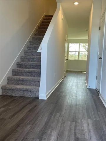 a view of entryway and hall with wooden floor