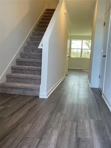 a view of entryway and hall with wooden floor