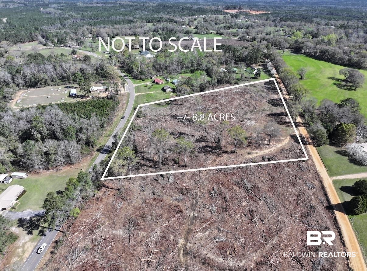 Aerial overview of property's location featuring a heavily wooded area and property boundaries highlighted