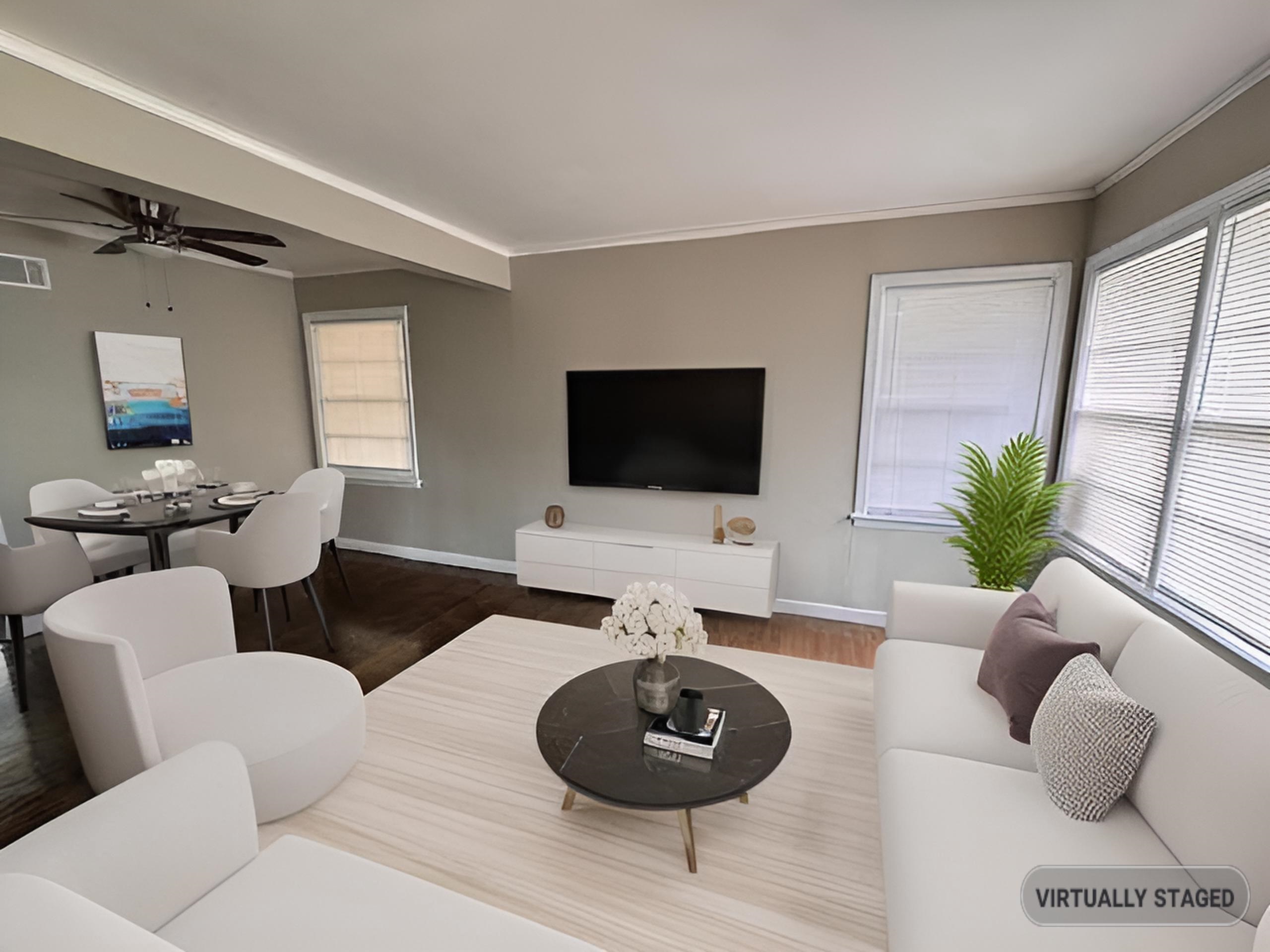 Living room featuring baseboards, wood finished floors, ceiling fan, healthy amount of natural light, and ornamental molding