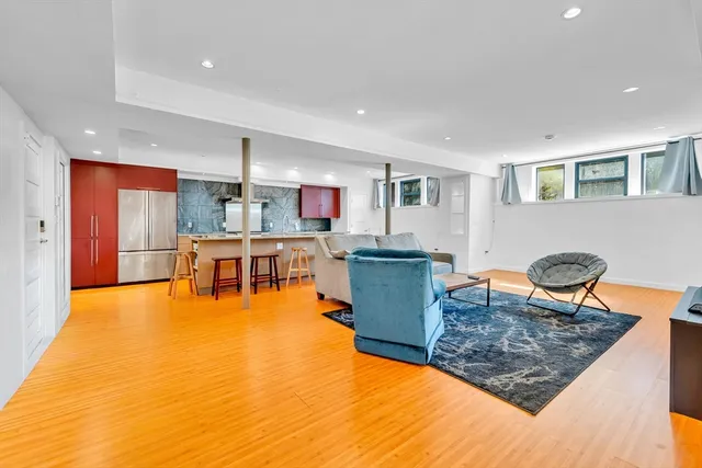 a living room with furniture a dining table and kitchen view