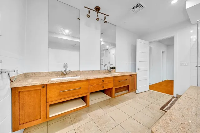 a large bathroom with a double vanity sink mirror and double