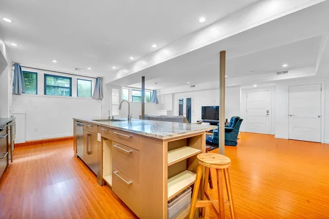 a kitchen with stainless steel appliances granite countertop a sink and a wooden cabinets