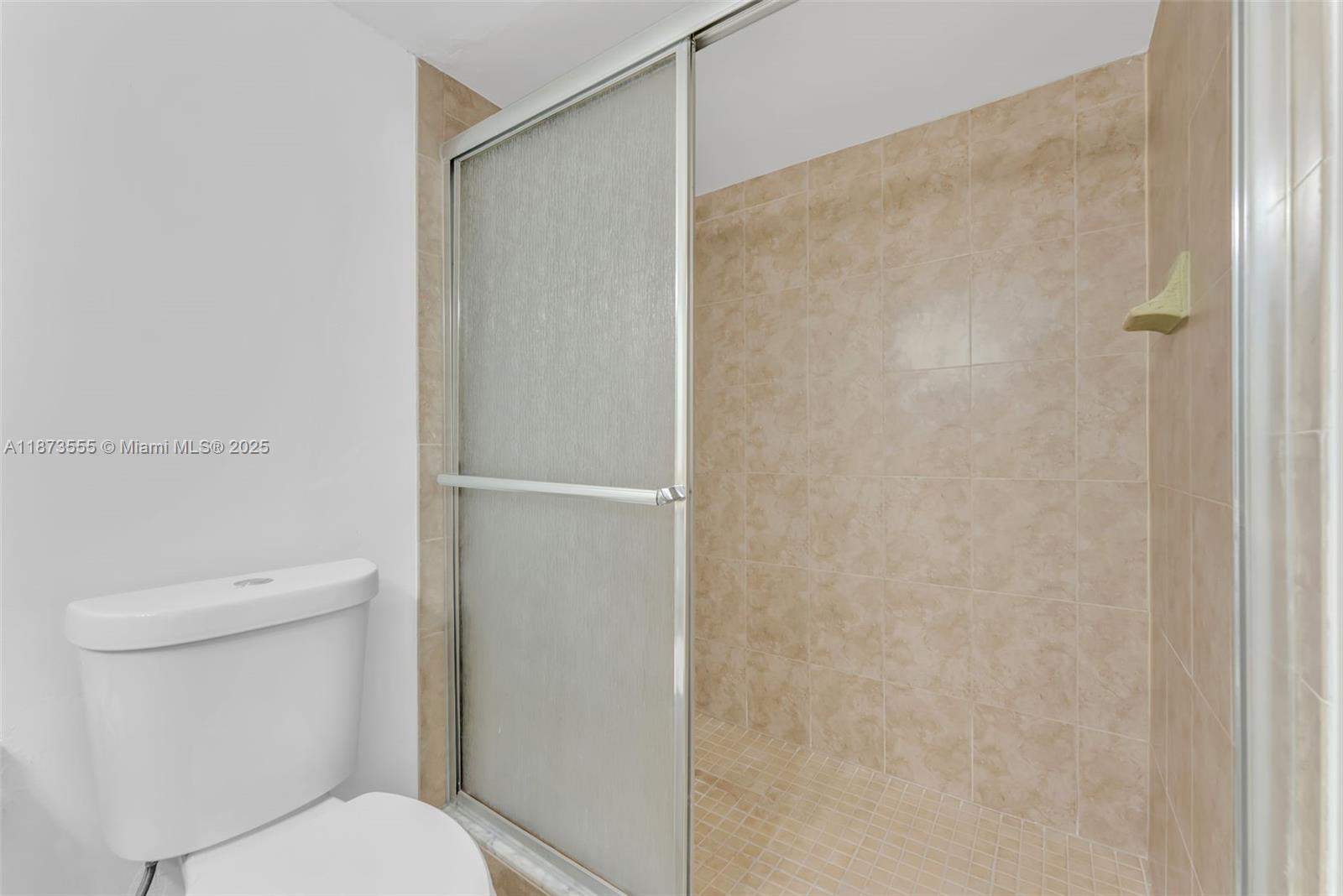 3100 North Pine Island Road, Unit 304 Sunrise, FL 33351 - Photo 14 of 24 a white toilet sitting next to a shower