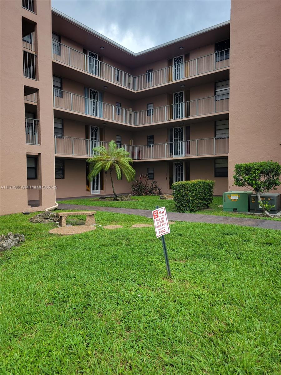 3100 North Pine Island Road, Unit 304 Sunrise, FL 33351 - Photo 22 of 24 a view of a house with a yard and a large tree