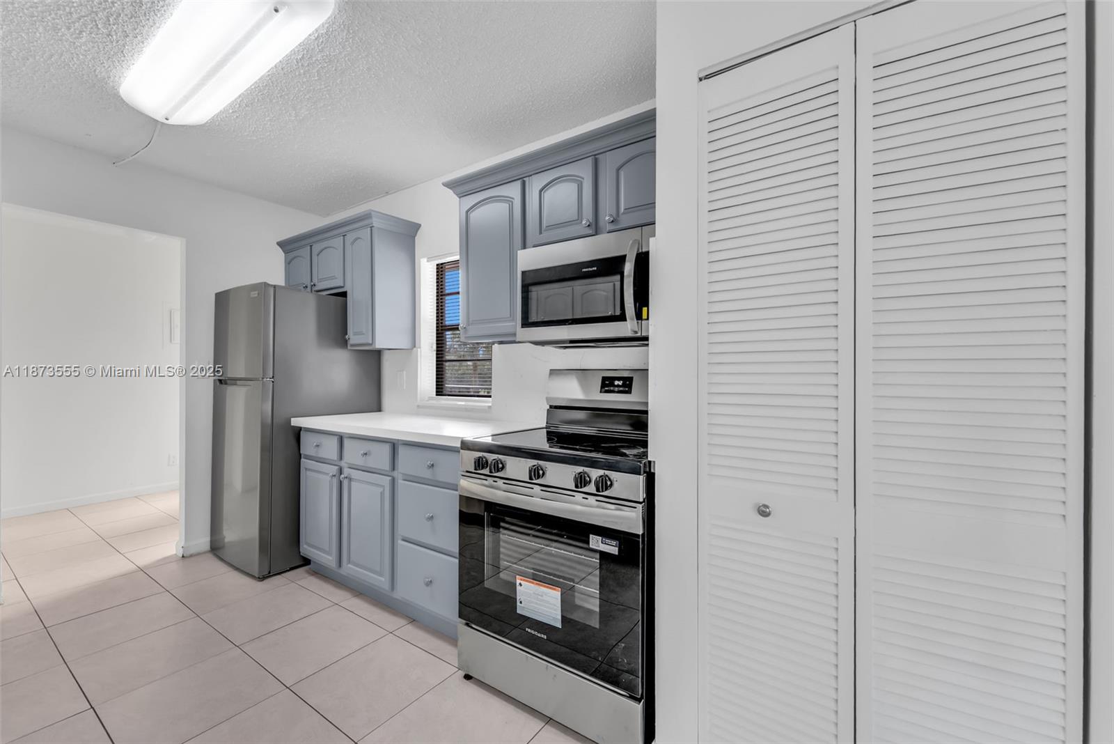 3100 North Pine Island Road, Unit 304 Sunrise, FL 33351 - Photo 4 of 24 a kitchen with stainless steel appliances granite countertop a refrigerator and a stove top oven