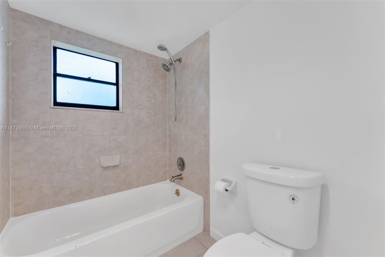 3100 North Pine Island Road, Unit 304 Sunrise, FL 33351 - Photo 8 of 24 a bathroom with a toilet and a bathtub