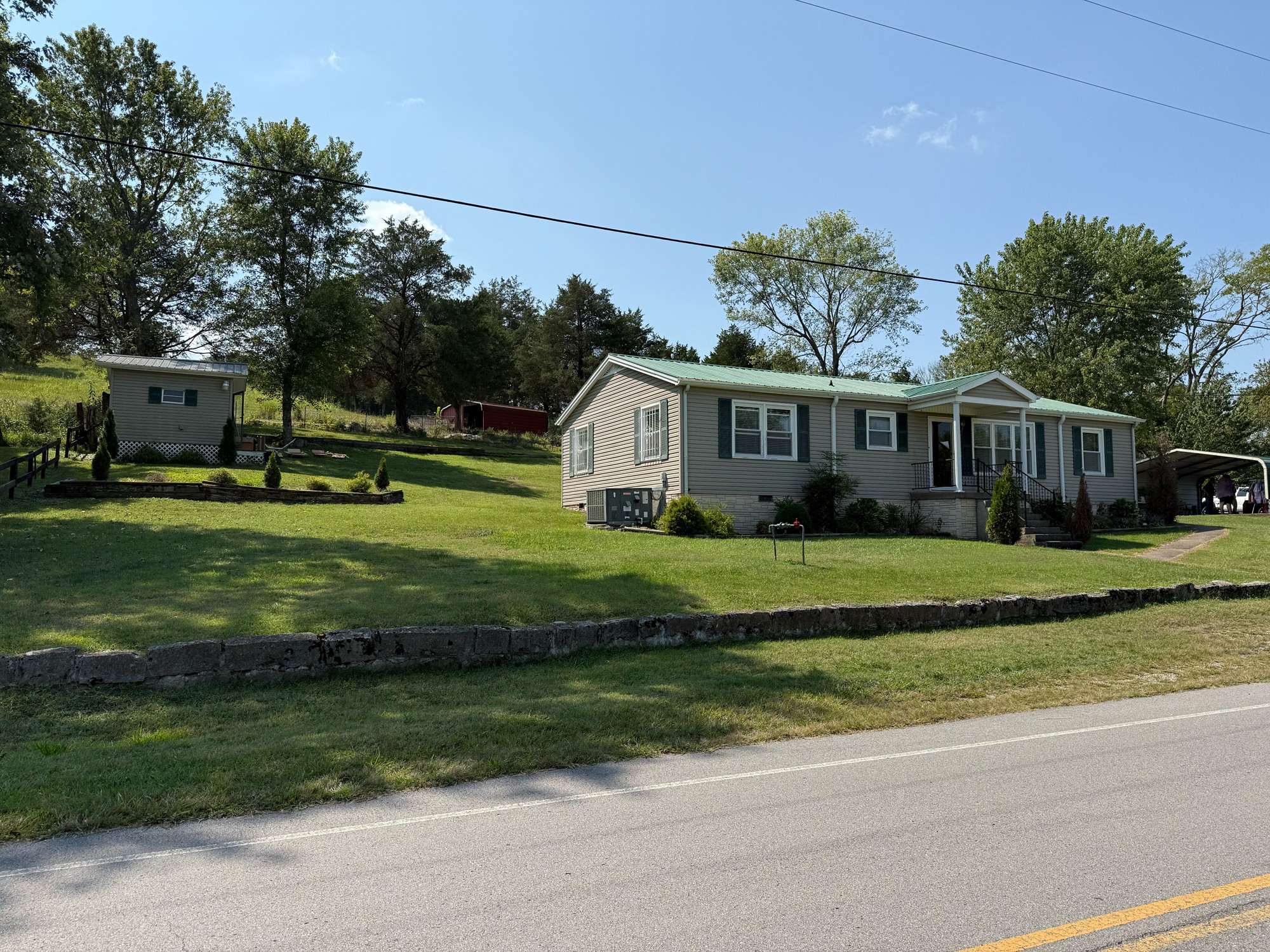 636 Old Alexandria Road Watertown, TN 37184 - Photo 5 of 8 a front view of a house with a garden and trees