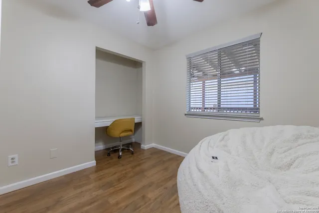 a bedroom with a bed and a chair