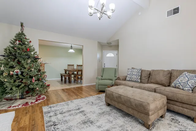 a living room with furniture and a christmas tree