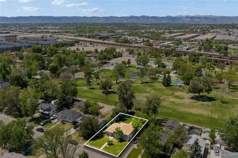 an aerial view of residential house with outdoor space and trees all around