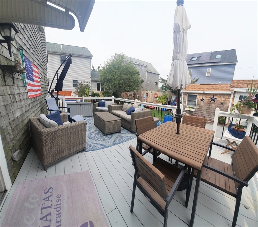 24 Pine Point Road, Unit 24 Duxbury, MA 02332 - Photo 2 of 12 a outdoor space with patio the couches and a dining table with the ocean view