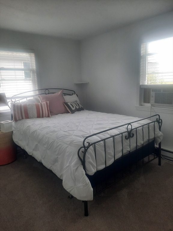 24 Pine Point Road, Unit 24 Duxbury, MA 02332 - Photo 6 of 12 a bed sitting in a bedroom next to a window