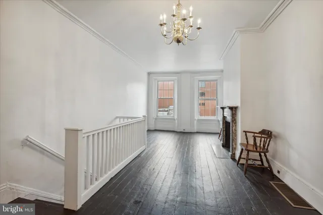 a view of a livingroom with wooden floor and stairs