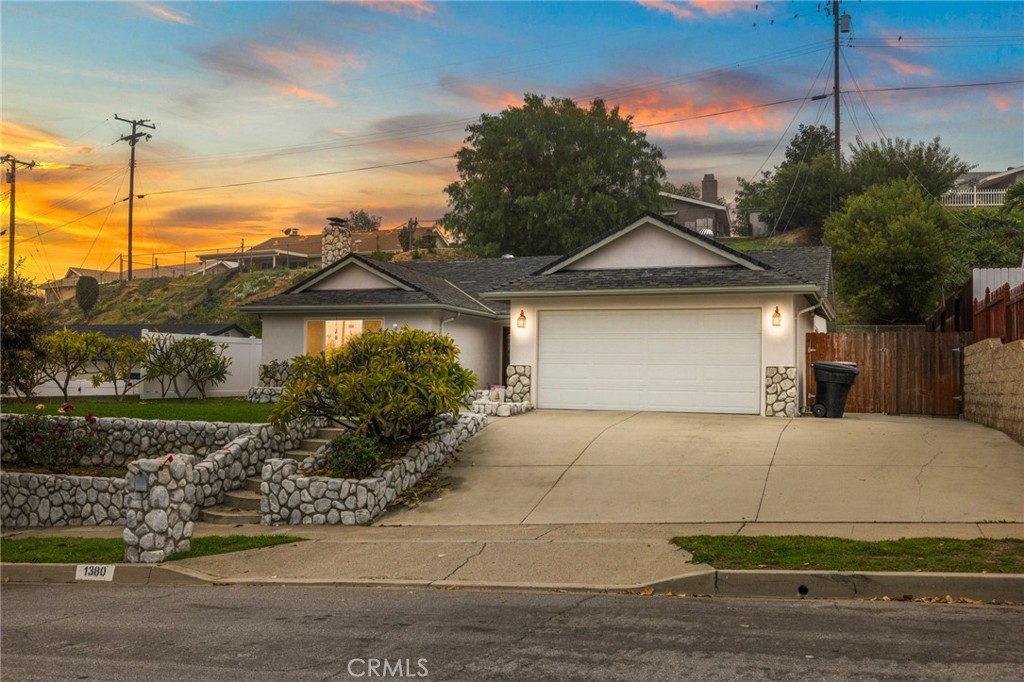 a front view of a house with a garden