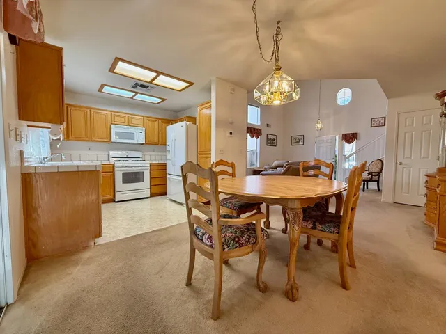 a view of a dining room with furniture and chandelier