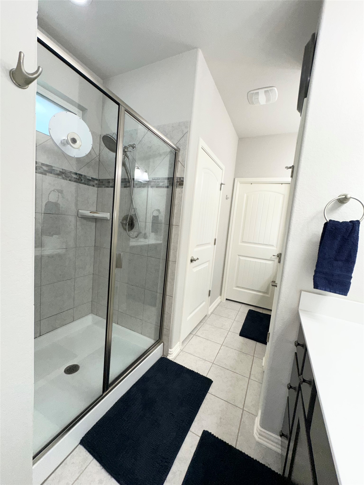 5721 Baythorne Drive Austin, TX 78747 - Photo 10 of 22 a bathroom with a glass shower door and a sink