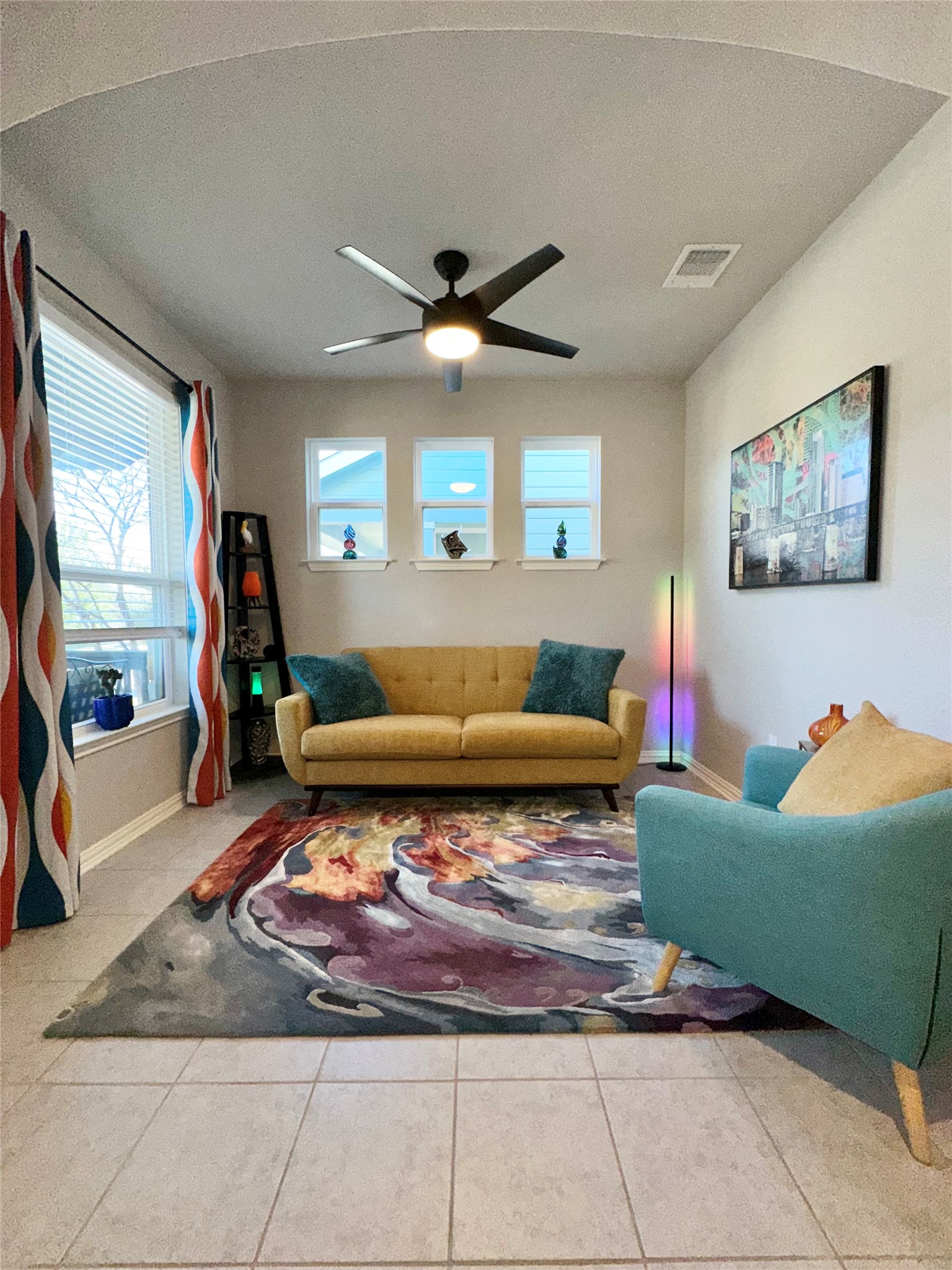 5721 Baythorne Drive Austin, TX 78747 - Photo 3 of 22 a living room with furniture a rug and a chandelier