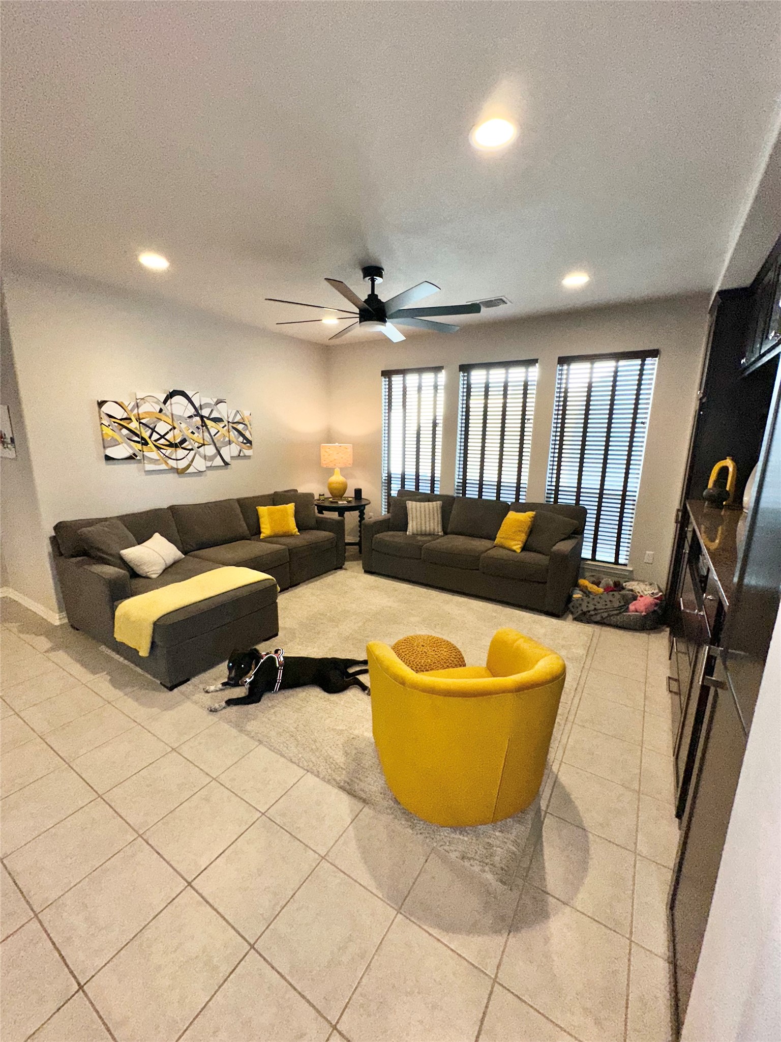 5721 Baythorne Drive Austin, TX 78747 - Photo 22 of 22 a living room with a couch and a flat screen tv