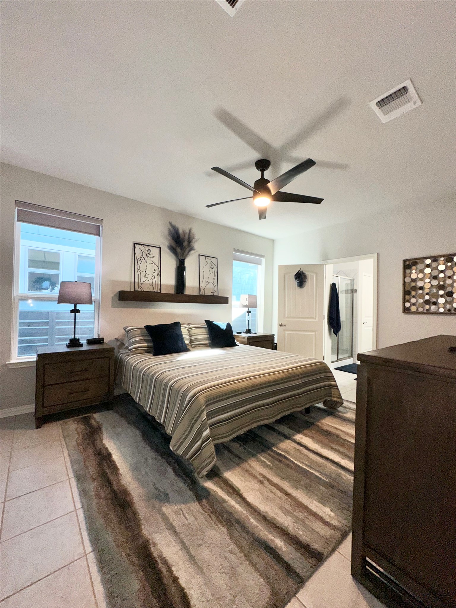 5721 Baythorne Drive Austin, TX 78747 - Photo 9 of 22 a bedroom with a bed and a couch