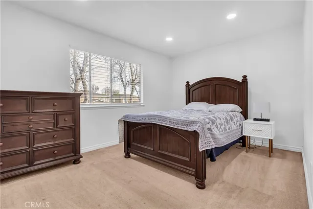 a bedroom with a bed and a dresser