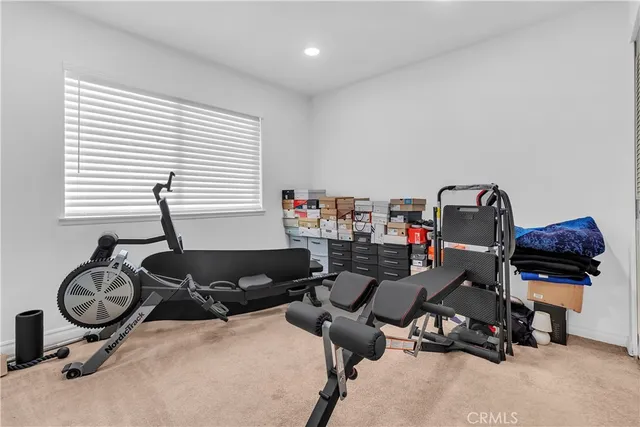 a room with gym equipment and a window
