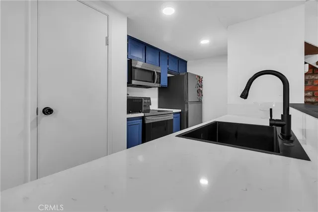 a kitchen with a sink a stove and refrigerator