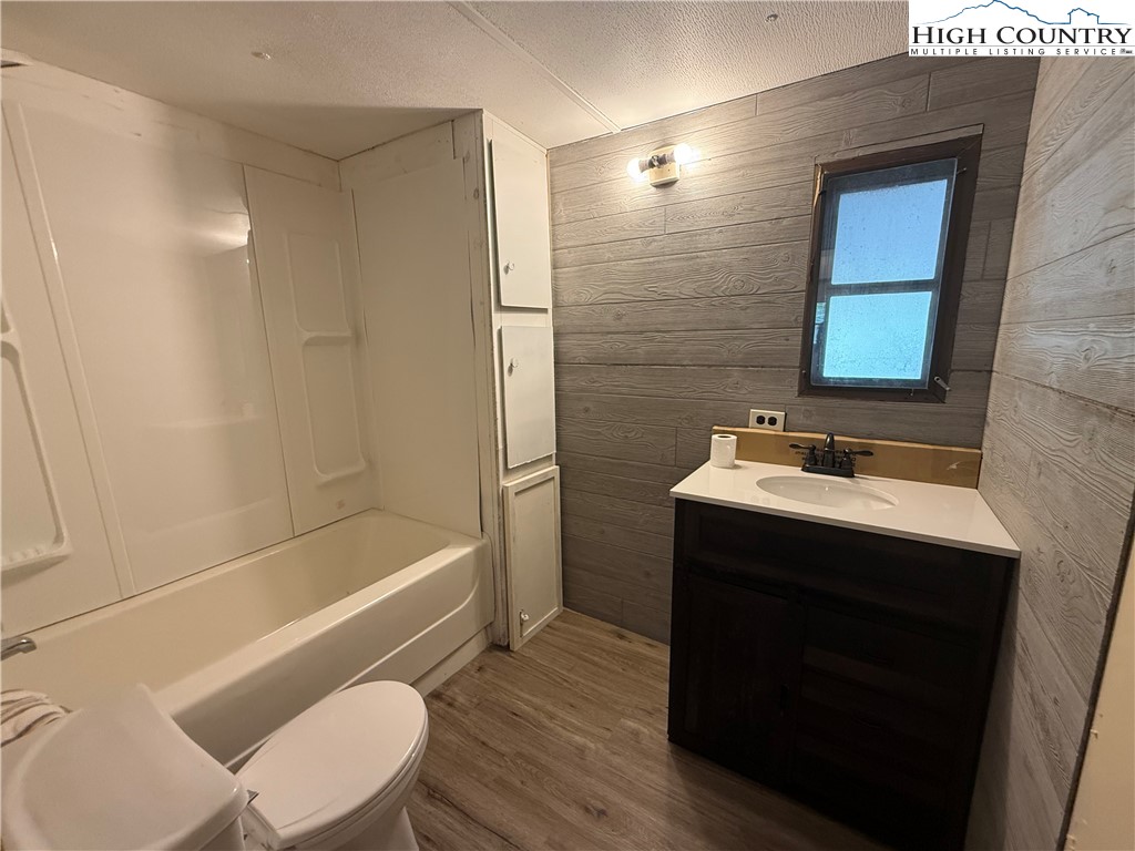 253 Bobby Rash Road Warrensville, NC 28693 - Photo 12 of 15 a bathroom with a sink a toilet and bathtub