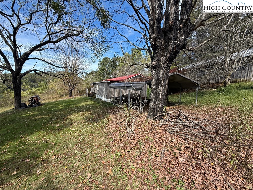 253 Bobby Rash Road Warrensville, NC 28693 - Photo 3 of 15 a backyard of a house with lots of green space