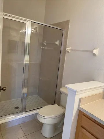 a bathroom with a shower a toilet and sink