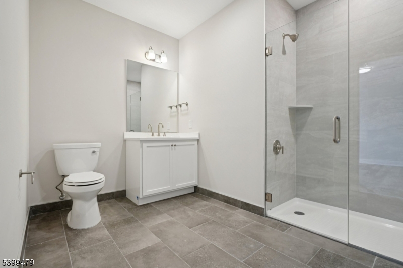 246 Main Street, Unit 202 Chatham, NJ 07928 - Photo 13 of 29 a bathroom with a toilet sink and shower