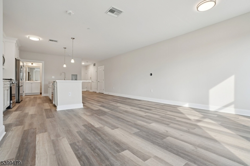 246 Main Street, Unit 202 Chatham, NJ 07928 - Photo 9 of 29 a view of an empty room with wooden floor