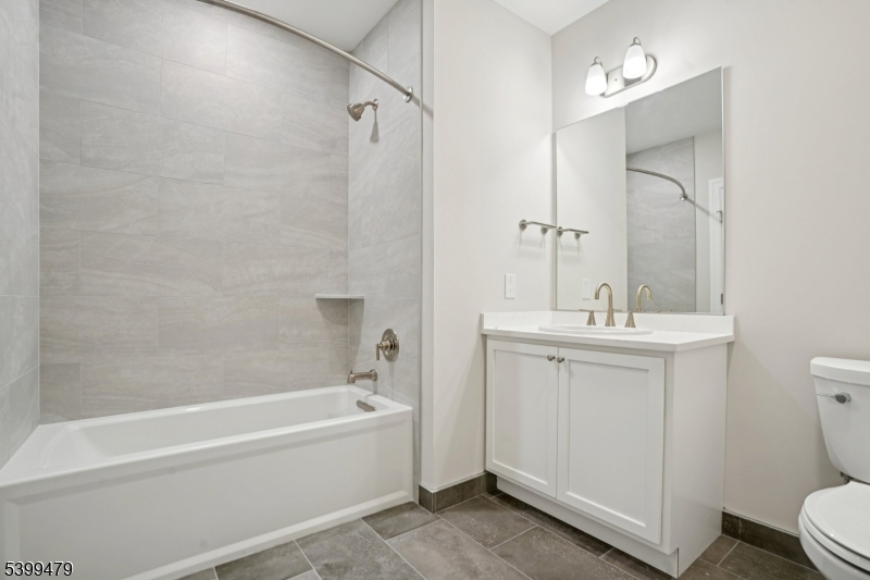 246 Main Street, Unit 202 Chatham, NJ 07928 - Photo 10 of 29 a bathroom with a sink a toilet and shower