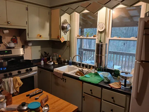 a kitchen with stainless steel appliances granite countertop a sink a stove and a wooden floors