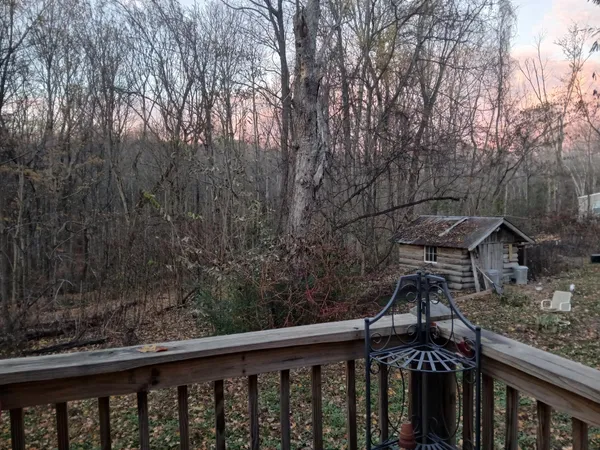 a balcony with wooden floor and outdoor space