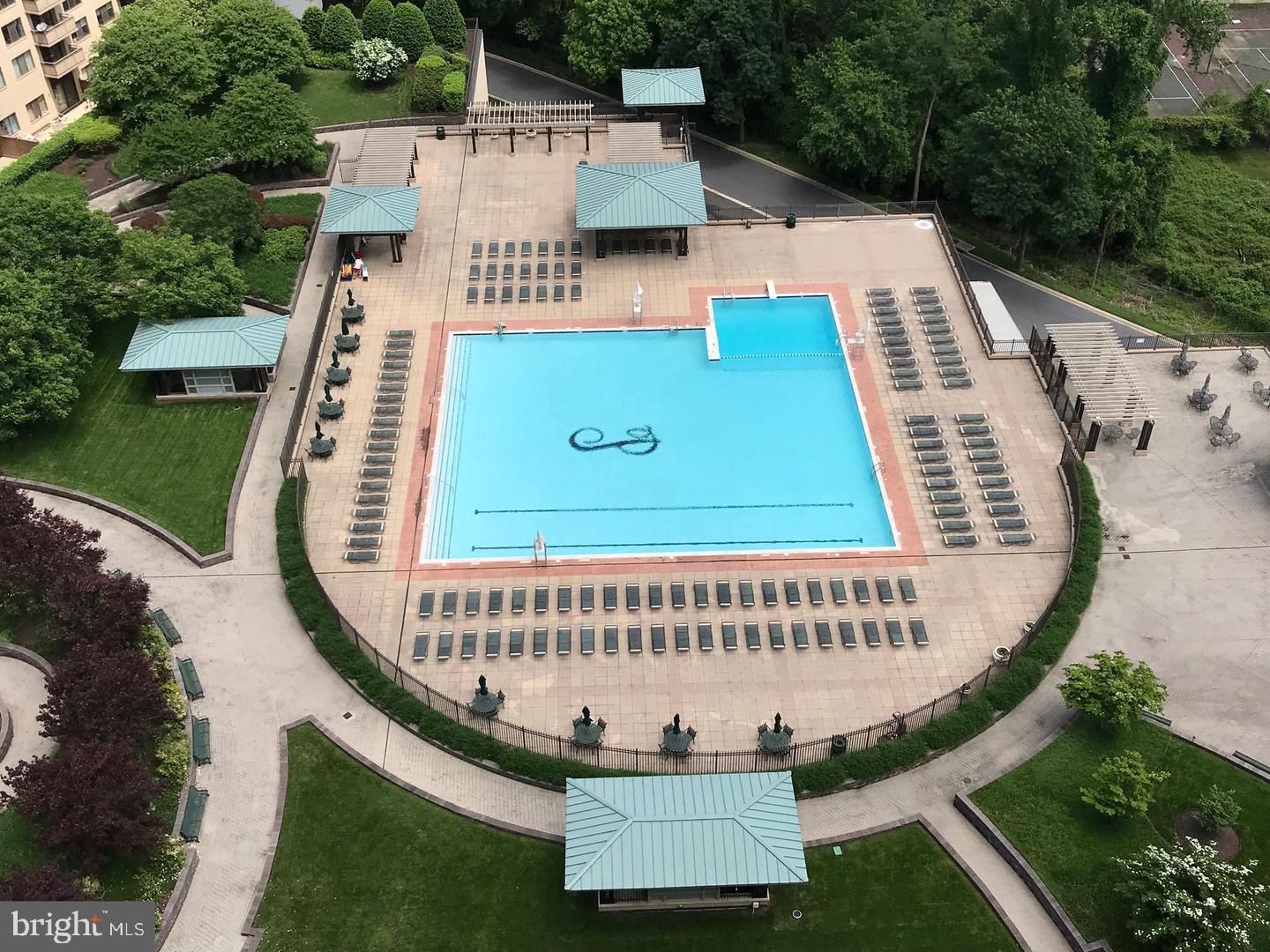 an aerial view of a house with swimming pool and deck