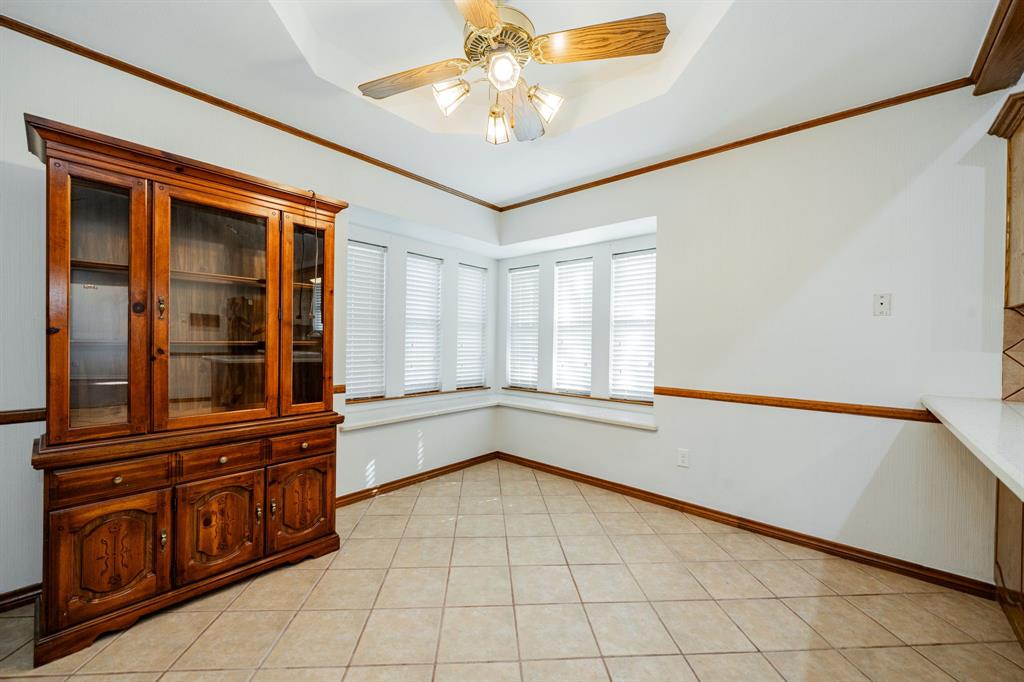 8304 Navigation Drive Rowlett, TX 75088 - Photo 14 of 40 Unfurnished dining area featuring ornamental molding, light tile patterned floors, and ceiling fan