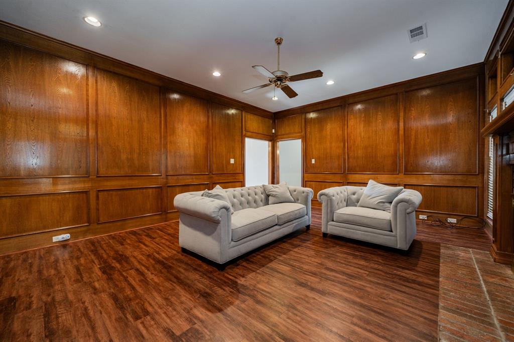 8304 Navigation Drive Rowlett, TX 75088 - Photo 23 of 40 Living room with a ceiling fan, wooden walls, dark wood-type flooring, and recessed lighting