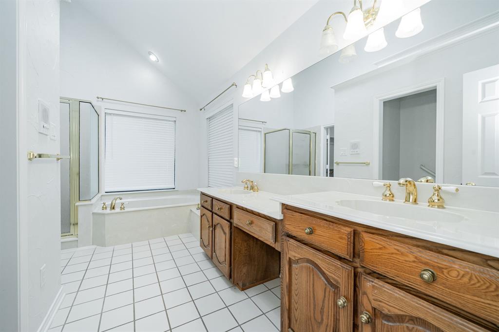 8304 Navigation Drive Rowlett, TX 75088 - Photo 27 of 40 Full bath featuring lofted ceiling, a shower stall, double vanity, a bath, and light tile patterned flooring