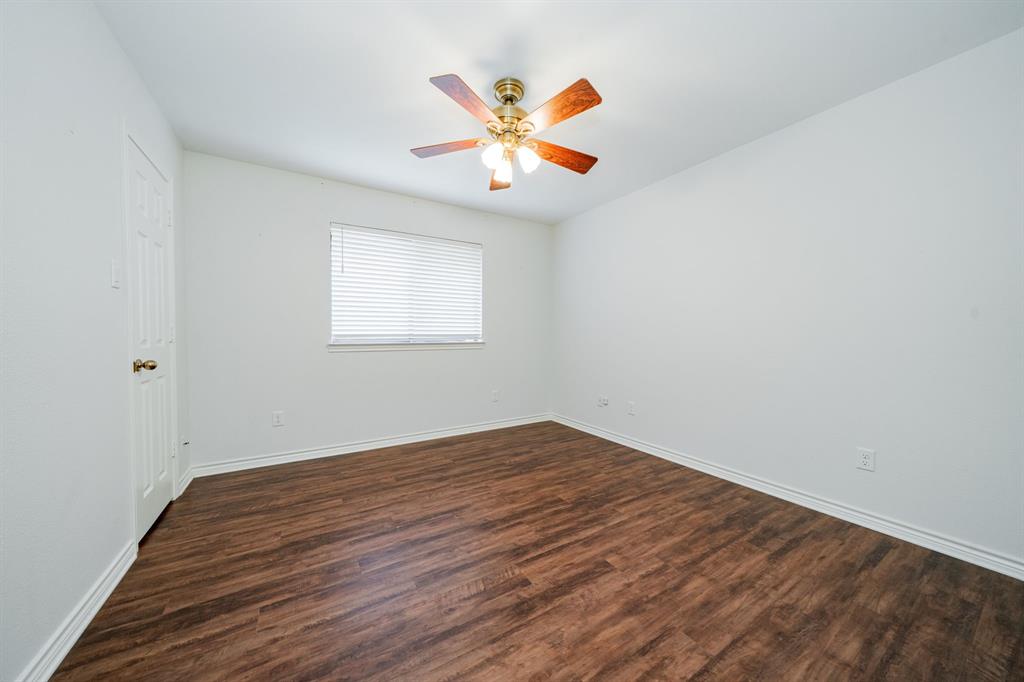 8304 Navigation Drive Rowlett, TX 75088 - Photo 30 of 40 Spare room featuring dark wood-style floors and ceiling fan