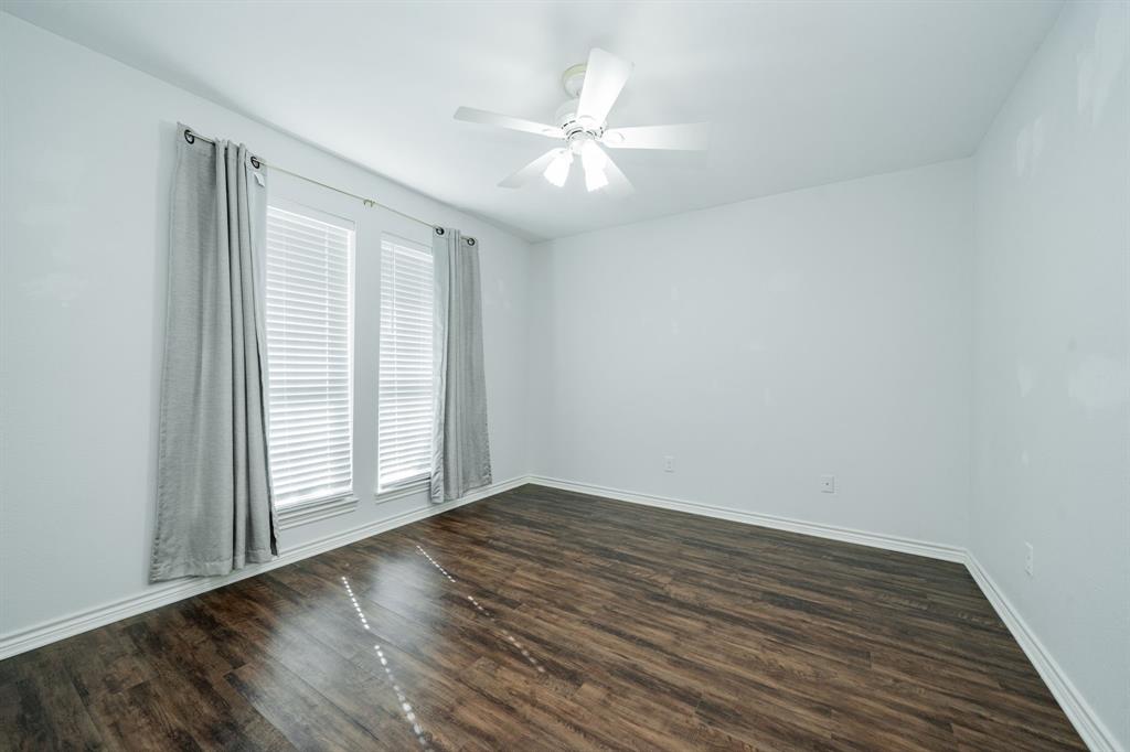 8304 Navigation Drive Rowlett, TX 75088 - Photo 33 of 40 Empty room featuring dark wood-style flooring and a ceiling fan