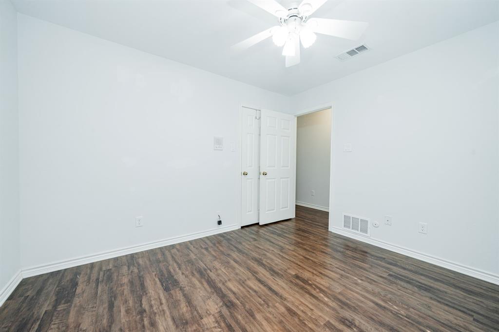 8304 Navigation Drive Rowlett, TX 75088 - Photo 34 of 40 Empty room featuring dark wood-style flooring and ceiling fan