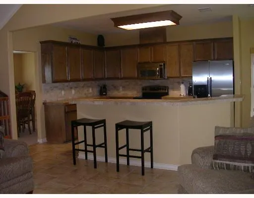 a kitchen with stainless steel appliances kitchen island granite countertop a stove a sink and a microwave