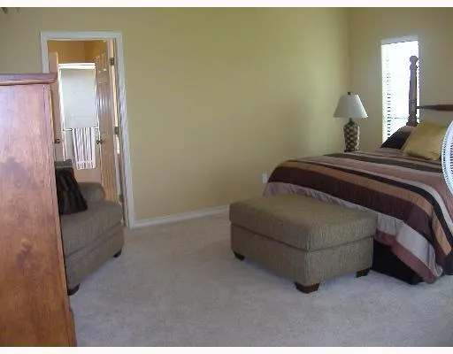 a bedroom with a bed and a mirror