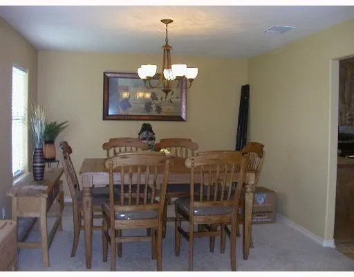 a view of a dining room with furniture and chandelier