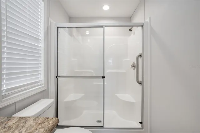 a bathroom with a glass shower door