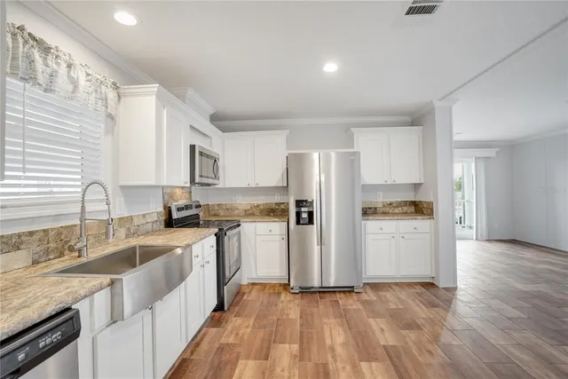 a kitchen with a refrigerator and a sink