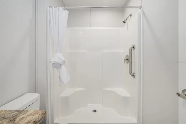a bathroom with a shower and toilet