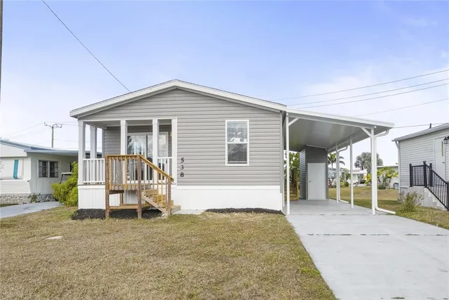 a view of a house with backyard porch and sitting area